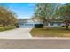 Two-car garage and light blue house with a spacious yard at 1520 Royal Forest Loop, Lakeland, FL 33811