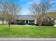 Brick house with a landscaped lawn and walkway at 1520 Royal Forest Loop, Lakeland, FL 33811