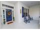 Front porch with blue door and rocking chairs at 1520 Royal Forest Loop, Lakeland, FL 33811