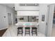 Kitchen with breakfast bar, three stools, and view into Gathering room at 1520 Royal Forest Loop, Lakeland, FL 33811