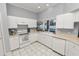 Kitchen boasts white cabinets, tile floors, and ample counter space at 1520 Royal Forest Loop, Lakeland, FL 33811
