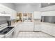 Bright kitchen features white cabinets, tile floors, and a view of the backyard at 1520 Royal Forest Loop, Lakeland, FL 33811