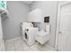 Laundry room with washer, dryer, utility sink, and overhead cabinets at 1520 Royal Forest Loop, Lakeland, FL 33811