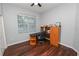 Home office with wood desk, chair, and built-in shelving at 1520 Royal Forest Loop, Lakeland, FL 33811