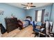 Bright bedroom with wood-look floors, ceiling fan, and built-in workspace at 1655 Laurel Oaks Dr, Bartow, FL 33830