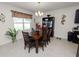 Dining area with a wood table and chairs, adjacent to the kitchen at 1655 Laurel Oaks Dr, Bartow, FL 33830