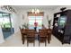 Bright dining room with wooden table and chairs, and access to the kitchen at 1655 Laurel Oaks Dr, Bartow, FL 33830