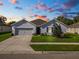 Curb appeal abounds in this charming one-story home, featuring a two-car garage and well-manicured lawn at 1655 Laurel Oaks Dr, Bartow, FL 33830