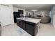 Open kitchen with an island, dark cabinets, and a breakfast bar at 1655 Laurel Oaks Dr, Bartow, FL 33830