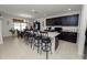 Modern kitchen with dark cabinetry, granite counters, and island with seating at 1655 Laurel Oaks Dr, Bartow, FL 33830
