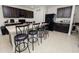 Modern kitchen with dark wood cabinets, granite countertops, and an island at 1655 Laurel Oaks Dr, Bartow, FL 33830