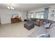 Spacious living room featuring a comfortable sectional sofa and tile flooring at 1655 Laurel Oaks Dr, Bartow, FL 33830