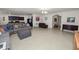 Open living room with tile floors, sectional sofa, and views into the kitchen and hallway at 1655 Laurel Oaks Dr, Bartow, FL 33830