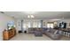 Spacious living room with tile floors, sectional sofa, and large windows at 1655 Laurel Oaks Dr, Bartow, FL 33830