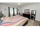 Main bedroom with king-size bed, dresser, and exercise bike at 1655 Laurel Oaks Dr, Bartow, FL 33830