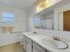 Bathroom with double vanity, shower, and linen storage at 1704 Pineberry Ct, Lakeland, FL 33803