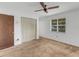 Bedroom with ceiling fan, window, and double door closet at 1704 Pineberry Ct, Lakeland, FL 33803