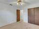 Bedroom with ceiling fan, wood paneling, and doors at 1704 Pineberry Ct, Lakeland, FL 33803
