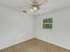 Bright bedroom with ceiling fan, window, and neutral carpeting at 1704 Pineberry Ct, Lakeland, FL 33803