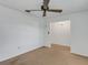 Bedroom with carpet, ceiling fan and access to another room at 1704 Pineberry Ct, Lakeland, FL 33803