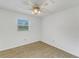 Bedroom with ceiling fan and window, neutral decor at 1704 Pineberry Ct, Lakeland, FL 33803