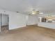 Bright living room with carpet, ceiling fan and open concept to kitchen at 1704 Pineberry Ct, Lakeland, FL 33803