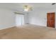 Spacious living room with carpet, ceiling fan and sliding glass doors at 1704 Pineberry Ct, Lakeland, FL 33803
