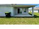 Covered patio with sliding glass doors at 2300 Crossandra St, Mascotte, FL 34753