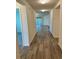 Bright hallway with wood-look tile floor at 2300 Crossandra St, Mascotte, FL 34753