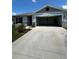 Home with white garage door and driveway at 2300 Crossandra St, Mascotte, FL 34753