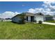 One story house with green lawn and blue sky at 2300 Crossandra St, Mascotte, FL 34753