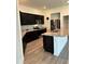 Modern kitchen with stainless steel appliances and an island at 2300 Crossandra St, Mascotte, FL 34753