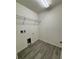 Laundry room with tile floor and shelving at 2300 Crossandra St, Mascotte, FL 34753