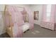 Charming bedroom with a canopy bed and a pink dresser at 2327 Northumberland Ct, Haines City, FL 33844