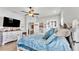 Main bedroom with king bed, dresser and large TV at 241 Walkers Point Dr, Auburndale, FL 33823