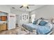 Bright bedroom with king bed, built-in shelving and access to hallway at 241 Walkers Point Dr, Auburndale, FL 33823