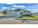 One-story home with two-car garage, palm trees, and manicured lawn at 241 Walkers Point Dr, Auburndale, FL 33823