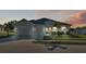 Two-car garage, gray house, palm trees at 241 Walkers Point Dr, Auburndale, FL 33823