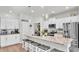 Modern kitchen with white cabinets, stainless steel appliances, and large island at 241 Walkers Point Dr, Auburndale, FL 33823