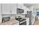 Well-equipped kitchen with stainless steel appliances and an eat-in island at 241 Walkers Point Dr, Auburndale, FL 33823