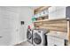Laundry room with washer, dryer, and extra storage at 241 Walkers Point Dr, Auburndale, FL 33823