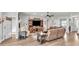 Spacious living room with hardwood floors, comfortable seating, and a large TV at 241 Walkers Point Dr, Auburndale, FL 33823