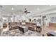 Open concept living room with hardwood floors, sectional sofa, and fireplace at 241 Walkers Point Dr, Auburndale, FL 33823