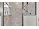 Walk-in shower with grey tile and glass enclosure at 241 Walkers Point Dr, Auburndale, FL 33823