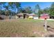 House exterior featuring a green color scheme, white garage door, and a rustic mailbox at 40939 W 4Th Ave, Umatilla, FL 32784