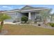 One-story home with gray siding, stone accents, and a landscaped front yard at 416 Monticelli Dr, Haines City, FL 33844