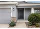 Modern front entry with gray door and stone accents at 416 Monticelli Dr, Haines City, FL 33844