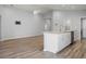 Open kitchen with island, stainless steel appliances, and wood-look flooring at 416 Monticelli Dr, Haines City, FL 33844
