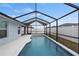 Inviting screened-in pool with a partially covered patio at 416 Monticelli Dr, Haines City, FL 33844