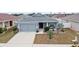 Single-story home with gray exterior, landscaping, and two-car garage at 416 Monticelli Dr, Haines City, FL 33844